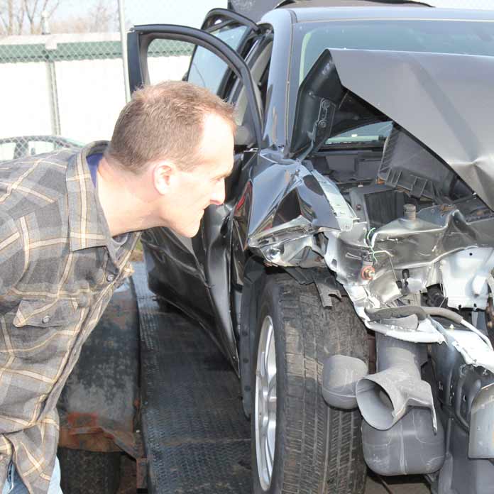 Attorney Hageman Insecting Car after Crash