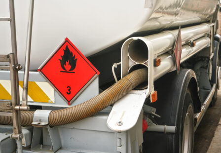 Gas station refueling truck with fire hazard sign on back