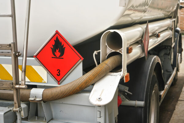 Gas station refueling truck with fire hazard sign on back